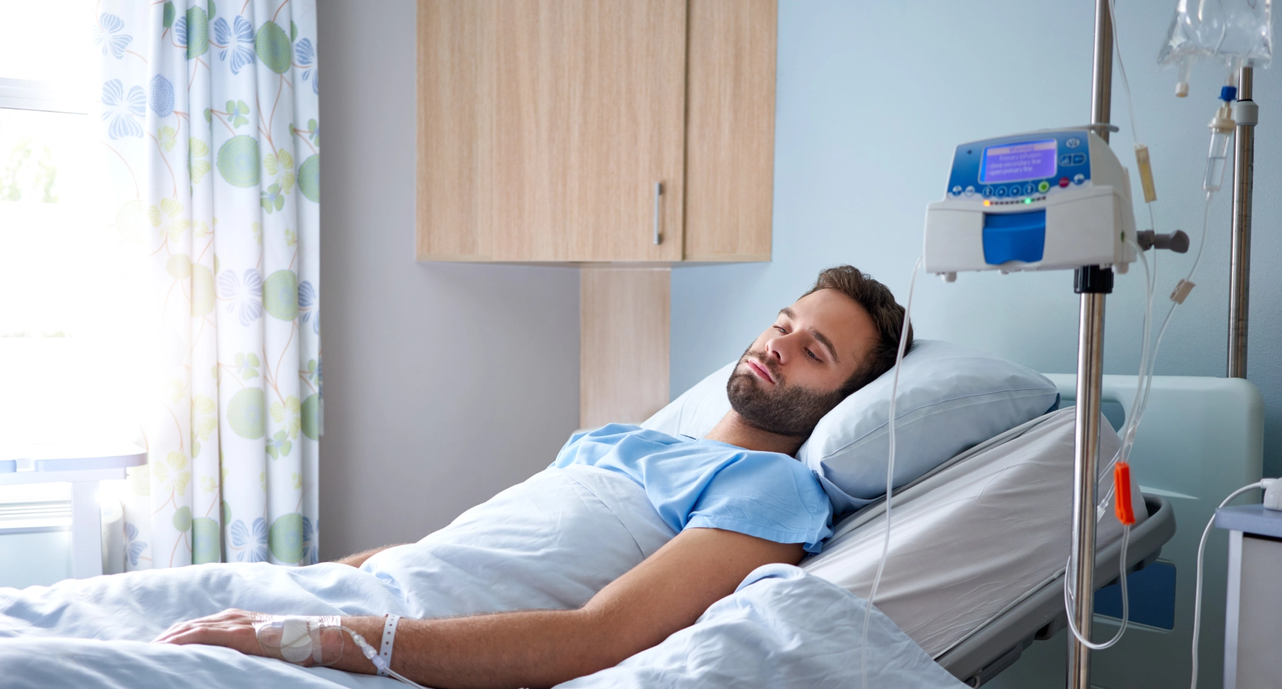 man laying in a hospital bed