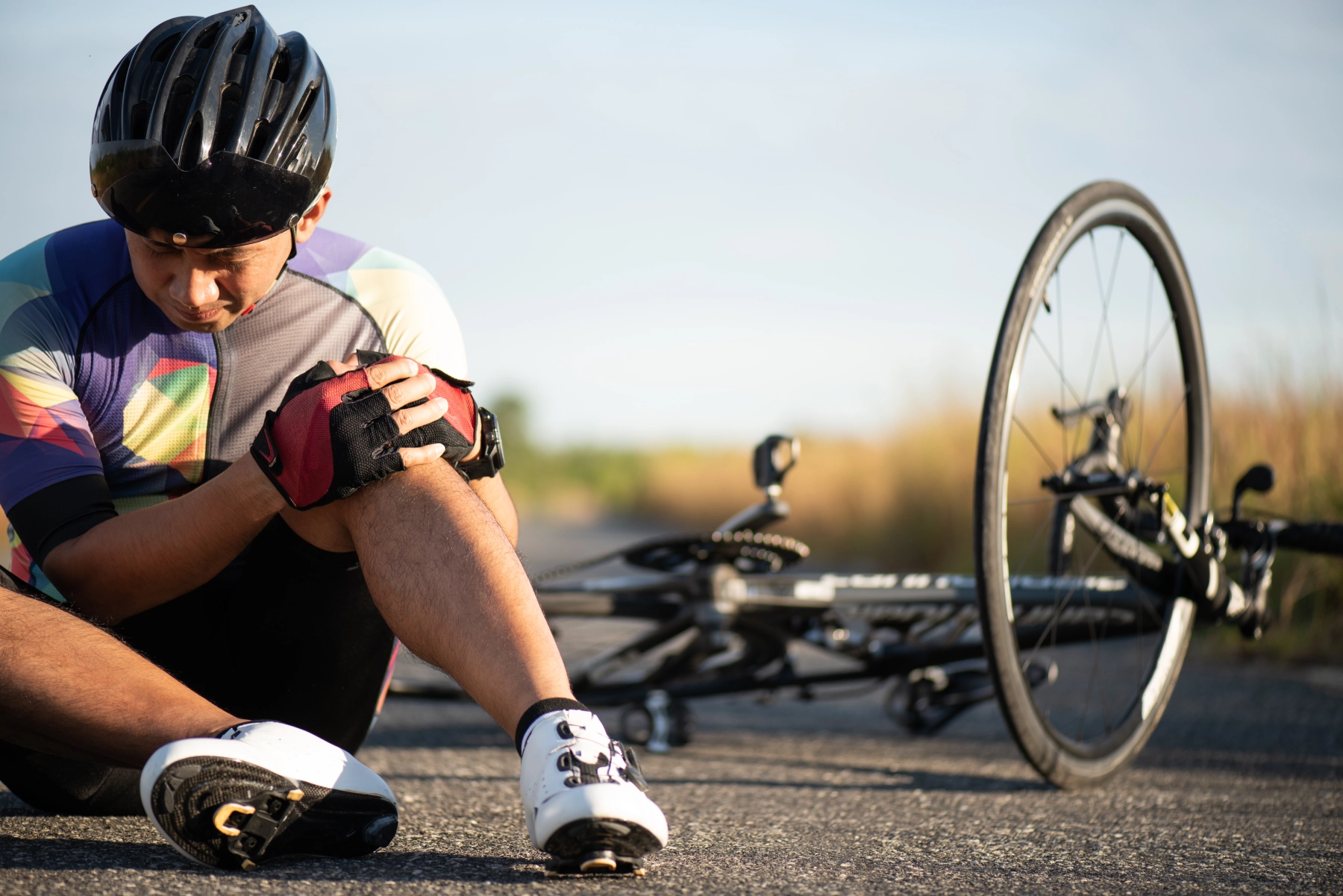 bicycle rider on the ground holding his knee after a las vegas bicycle accident