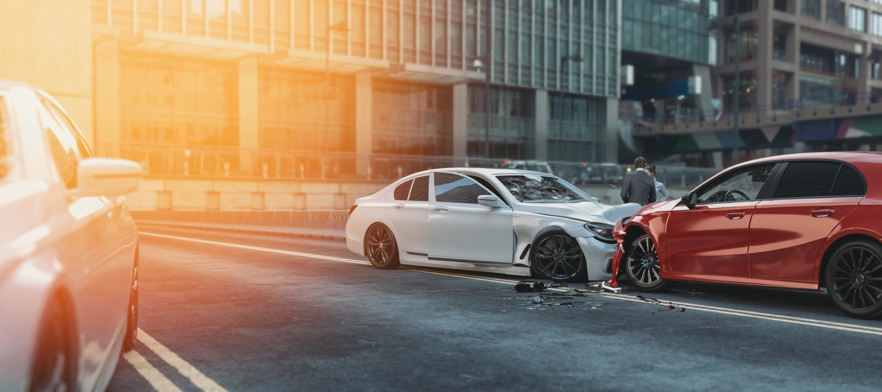 red and white vehicle crashed into each other while people are talking while standing next to the cars